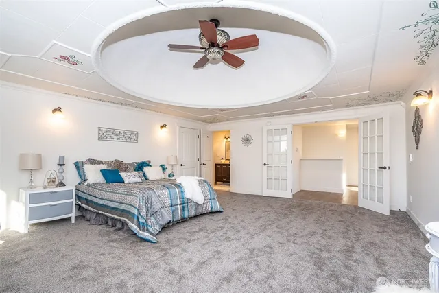 a bedroom with a bed and a chandelier