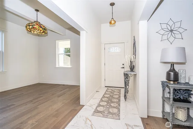 a view of an entryway with wooden floor