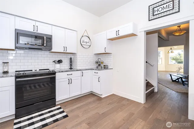 a kitchen with stainless steel appliances a stove a microwave and cabinets