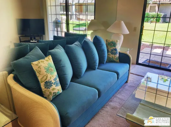 a living room with furniture and a large window