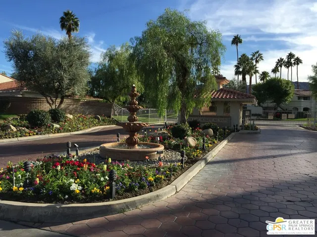 a view of a fountain in front of a house