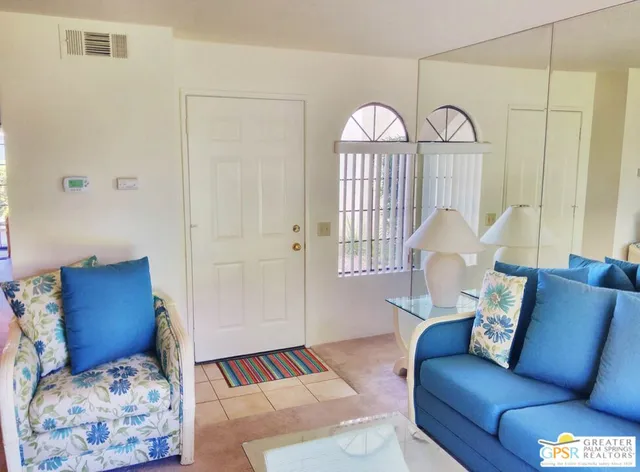 a living room with furniture a couch and a window