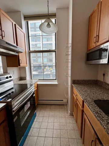 a kitchen with a sink a stove and cabinets