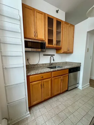 a kitchen with granite countertop a sink and a stove