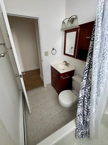 a bathroom with a sink a toilet and a mirror
