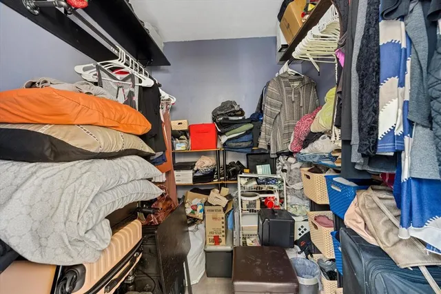 a room with a table chairs and a window