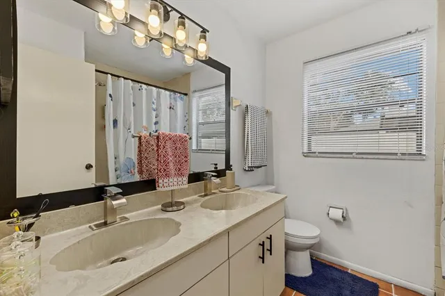 a bedroom with a bed a flat screen tv and dresser