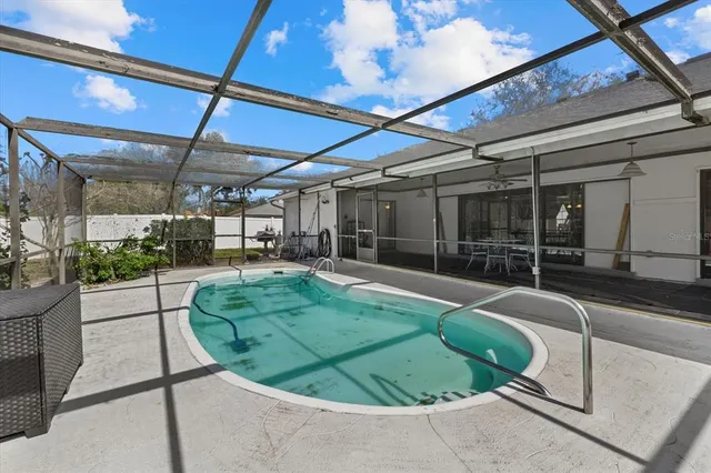 a view of a swimming pool with a patio