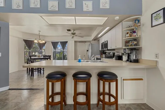 a kitchen with cabinets and chairs