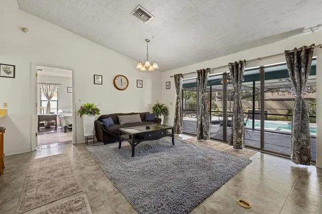 a living room with lots of furniture and a chandelier