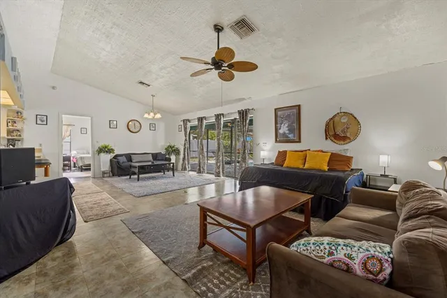 a living room with furniture a rug and a chandelier