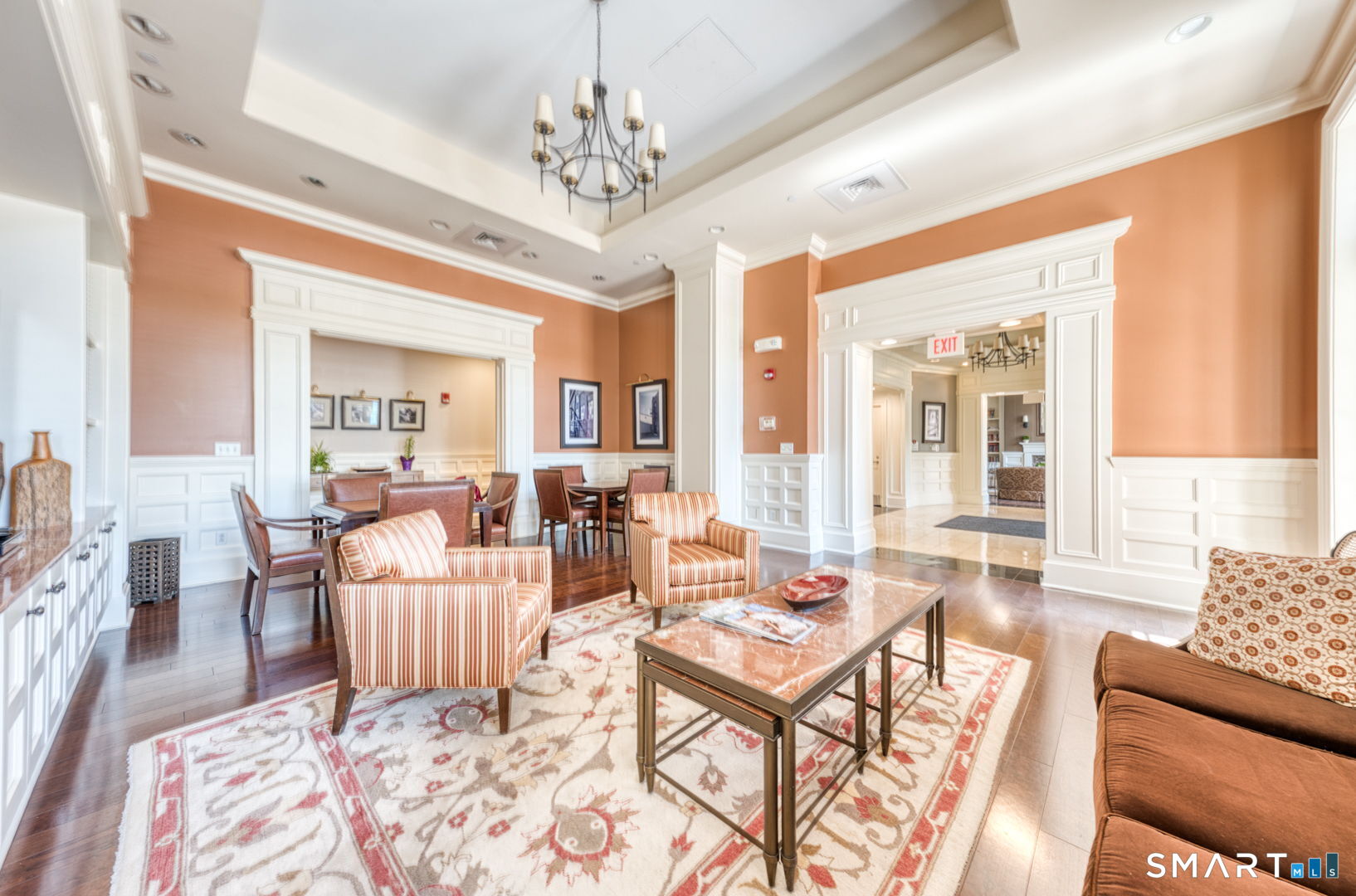 85 Memorial Road, Unit 411 West Hartford, CT 06107 - Photo 21 of 24 a living room with furniture and a chandelier