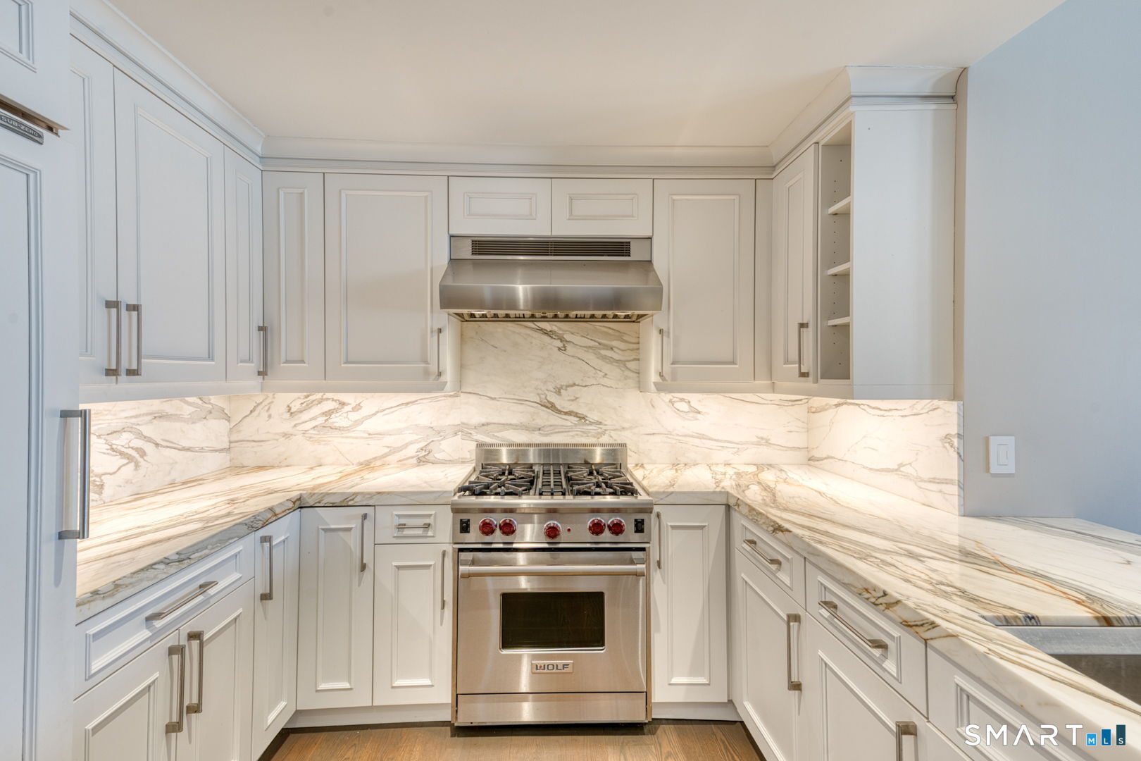 85 Memorial Road, Unit 411 West Hartford, CT 06107 - Photo 5 of 24 a kitchen with granite countertop white cabinets and white appliances