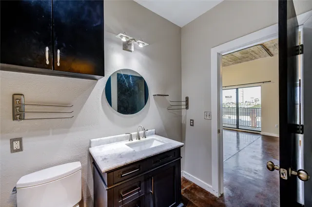 a bathroom with a sink a toilet and vanity