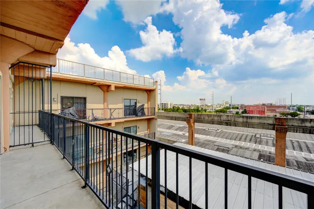 a view of roof deck with two couches and wooden floor
