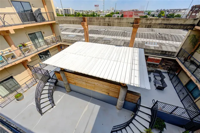 a view of a patio with table and chairs and potted plants