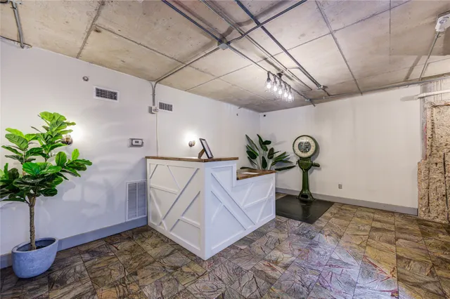 a view of a cars park in front of a building