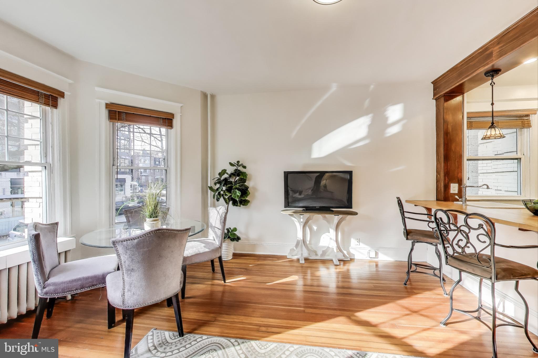1791 Lanier Place Northwest, Unit 2 Washington, DC 20009 - Photo 14 of 30 a living room with furniture a flat screen tv and a large window