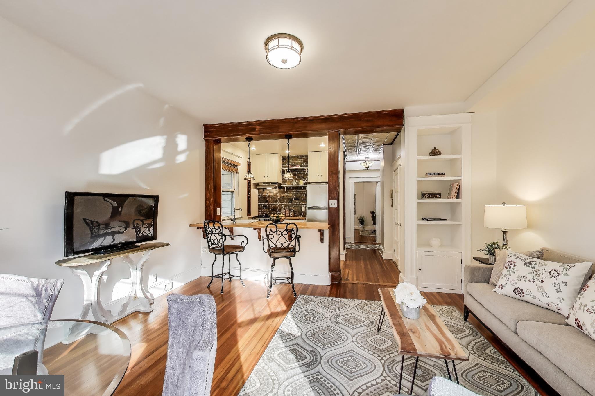 1791 Lanier Place Northwest, Unit 2 Washington, DC 20009 - Photo 15 of 30 a living room with furniture and a flat screen tv