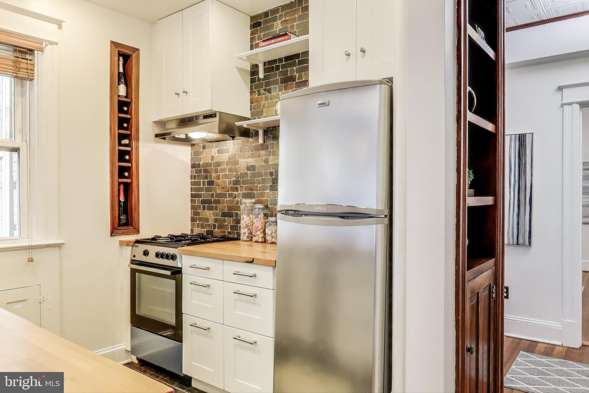 1791 Lanier Place Northwest, Unit 2 Washington, DC 20009 - Photo 19 of 30 a kitchen with a refrigerator and a stove