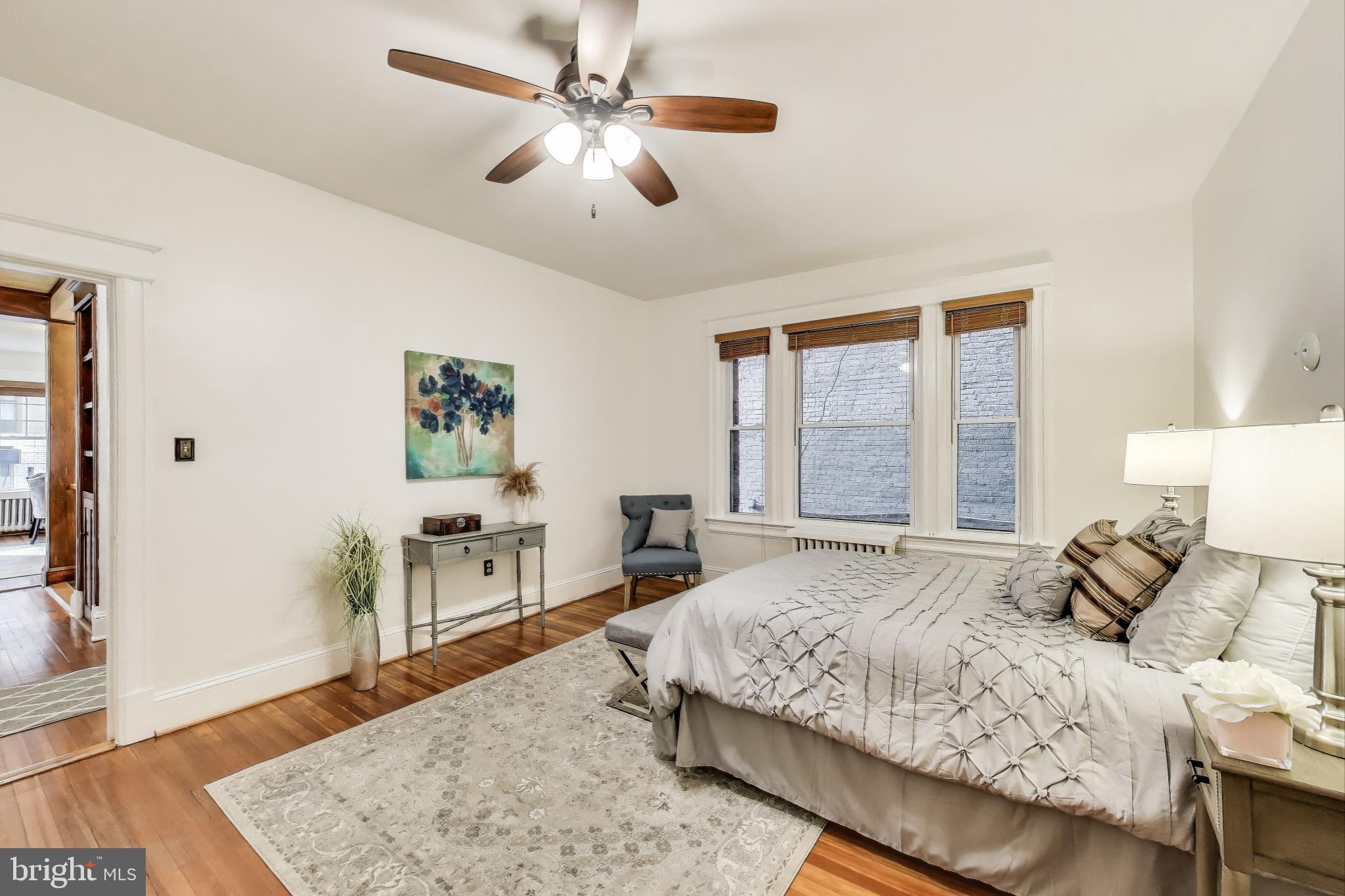 1791 Lanier Place Northwest, Unit 2 Washington, DC 20009 - Photo 22 of 30 a bedroom with a large bed a chandelier and a window