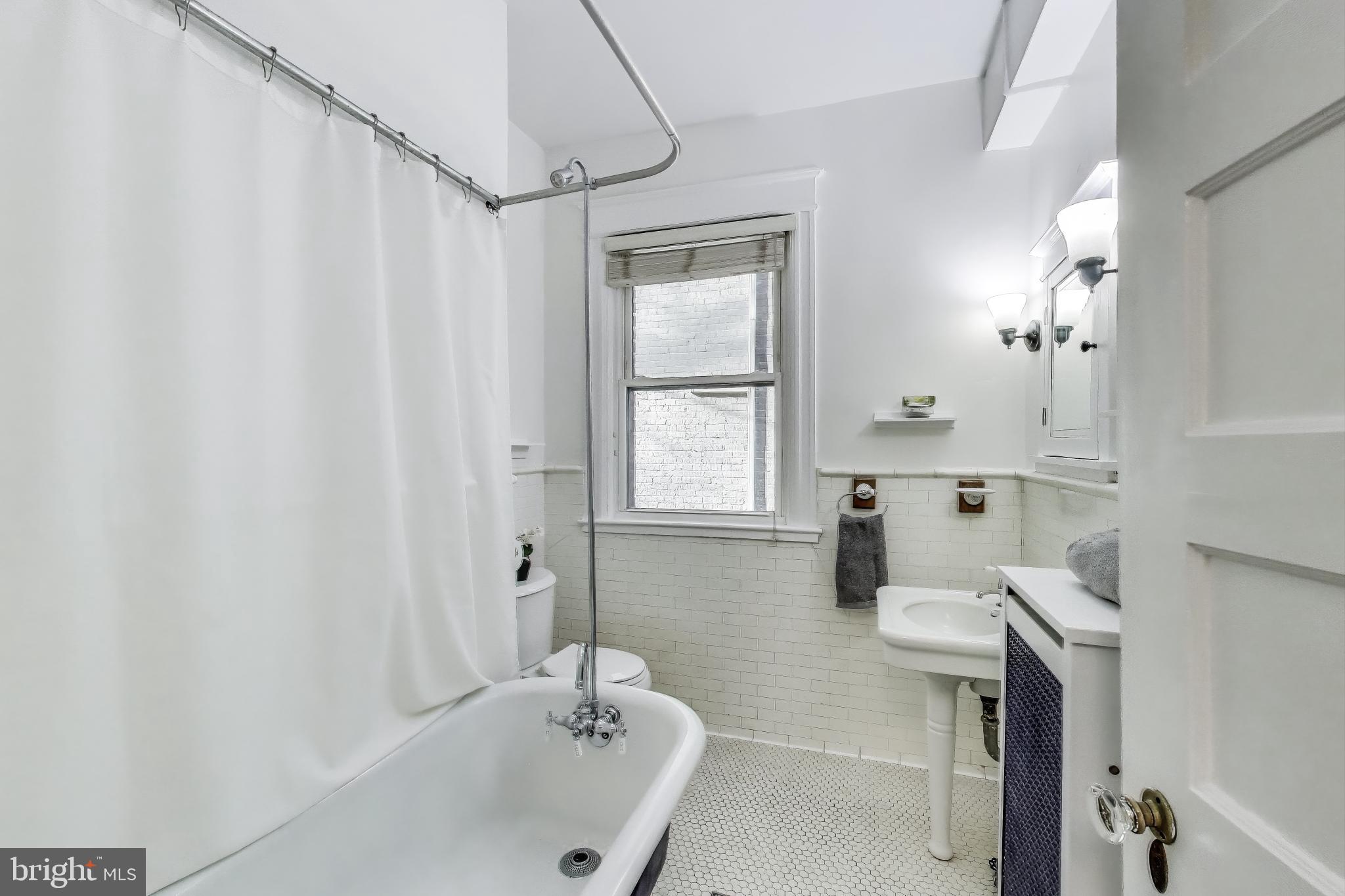 1791 Lanier Place Northwest, Unit 2 Washington, DC 20009 - Photo 24 of 30 a bathroom with a sink a toilet and shower