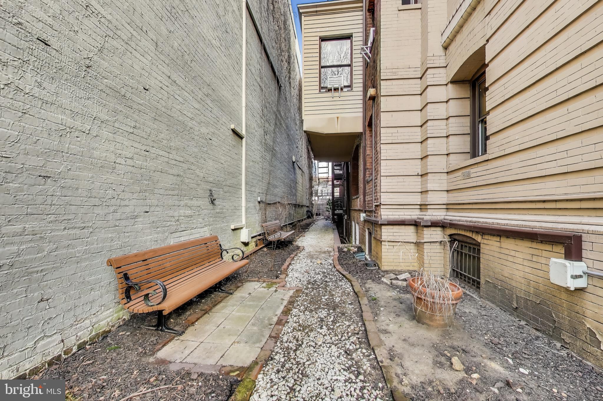 1791 Lanier Place Northwest, Unit 2 Washington, DC 20009 - Photo 29 of 30 a bench sitting in front of a building