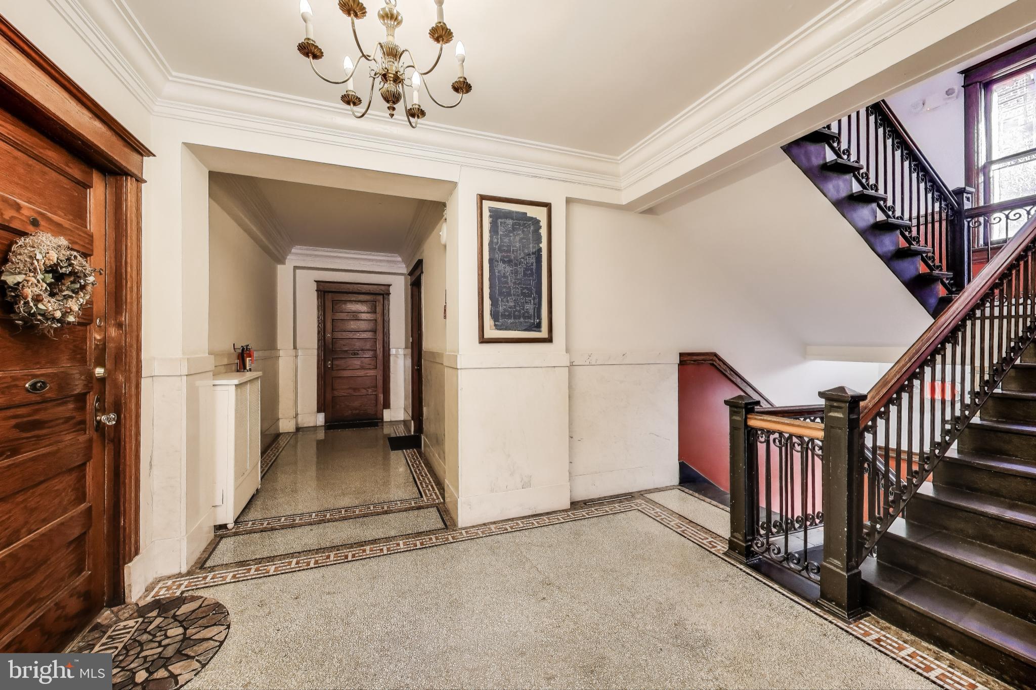 1791 Lanier Place Northwest, Unit 2 Washington, DC 20009 - Photo 9 of 30 a view of a hallway with entryway chandelier and front door