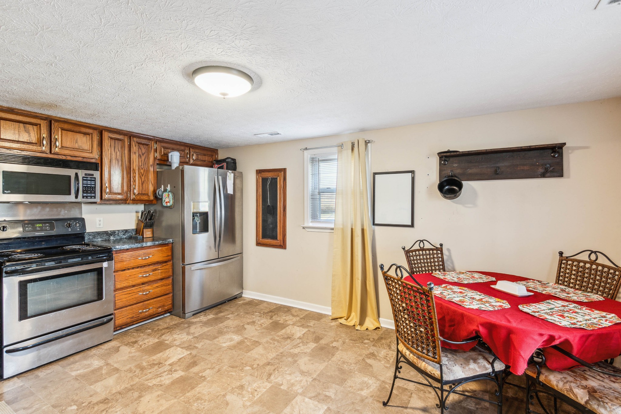 170 T G T Road Portland, TN 37148 - Photo 14 of 37 a kitchen that has a dining table and stainless steel appliances