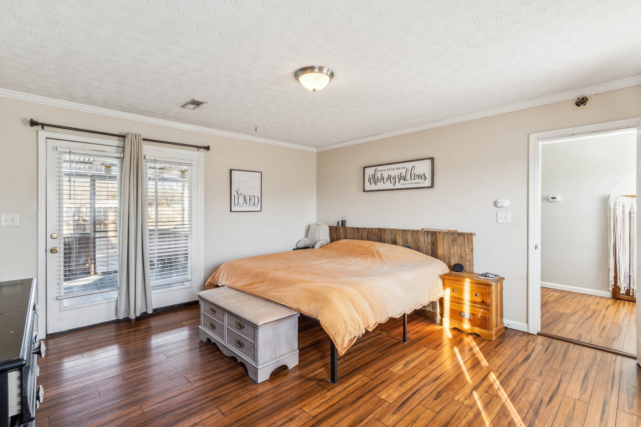 170 T G T Road Portland, TN 37148 - Photo 17 of 37 a spacious bedroom with a bed and wooden floor