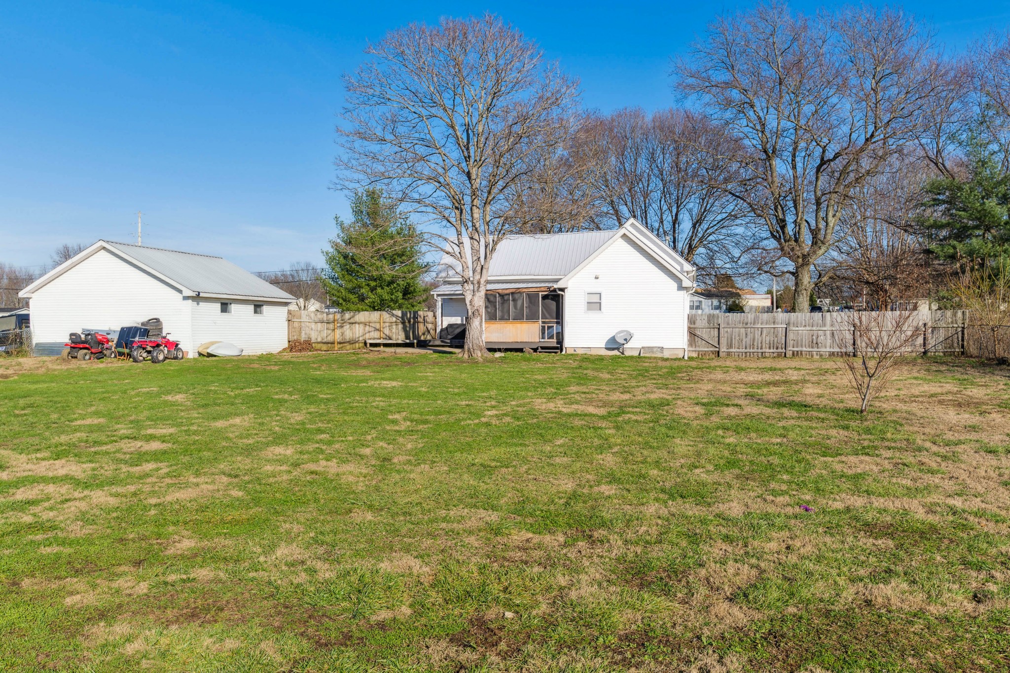 170 T G T Road Portland, TN 37148 - Photo 36 of 37 a view of a white house with a yard and large trees