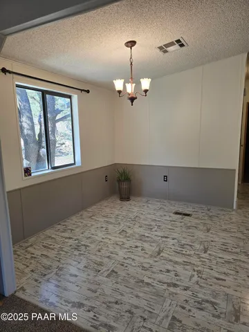 a view of a livingroom with furniture and staircase