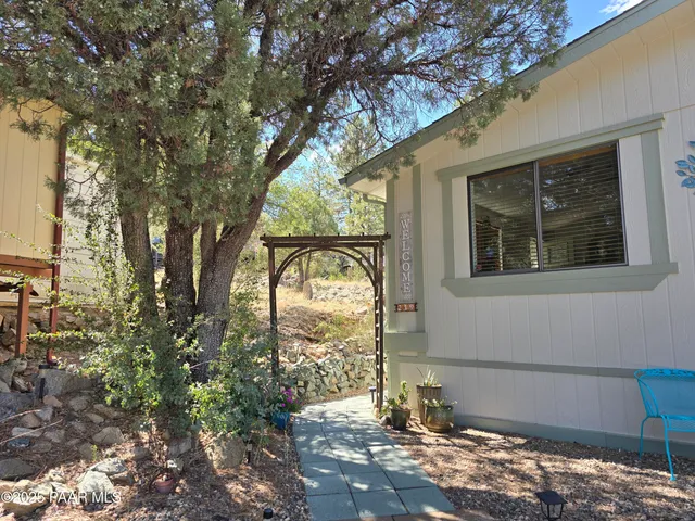a dining room with furniture and a floor to ceiling window