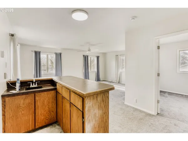 a kitchen with a stove a refrigerator a sink and cabinets