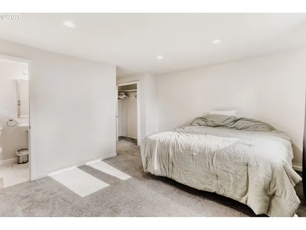 a bedroom with a bed and a view of bathroom