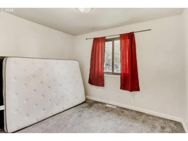 a room with a bed and a window