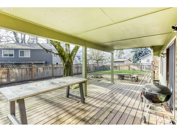 a view of a chairs and table on the wooden deck