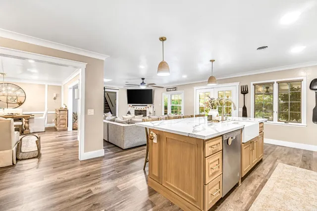 a large kitchen with kitchen island a sink counter space and living room view