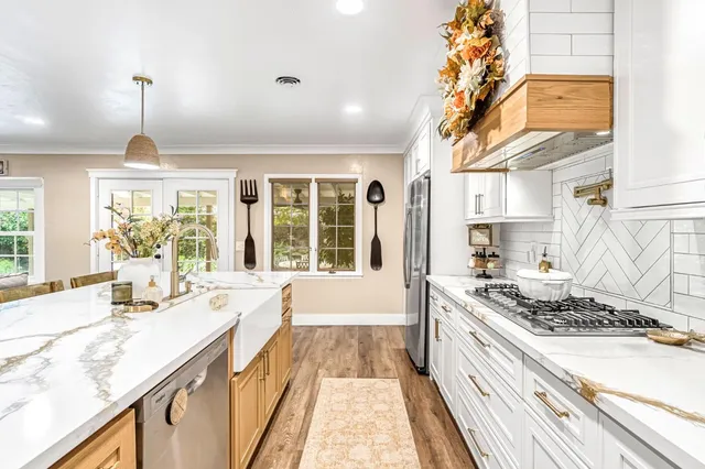 a kitchen with stove and window