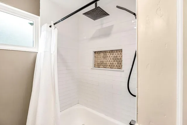 a bathroom with a shower and a shower head