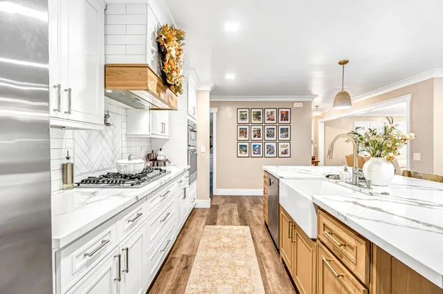 a kitchen with stainless steel appliances granite countertop a sink stove and cabinets