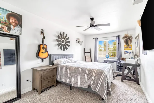a bedroom with a bed and a chandelier