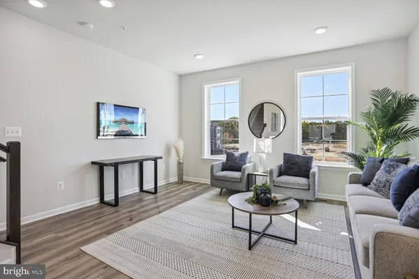 a living room with fireplace furniture and a wooden floor
