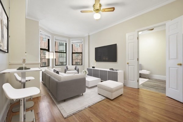 38-40 St Botolph Street, Unit 45 Boston, MA 02116 - Photo 1 of 8 a living room with furniture and a flat screen tv