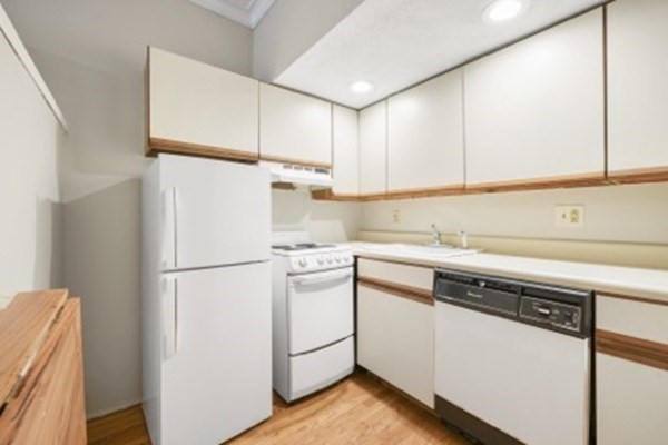 38-40 St Botolph Street, Unit 45 Boston, MA 02116 - Photo 2 of 8 a utility room with cabinets washer and dryer