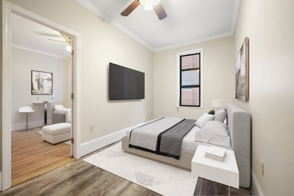 38-40 St Botolph Street, Unit 45 Boston, MA 02116 - Photo 3 of 8 a bedroom with a bed and a flat screen tv
