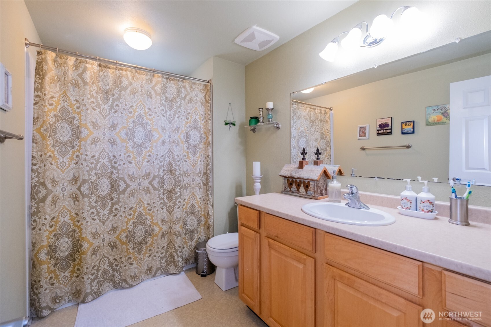 3780 Magrath Road Bellingham, WA 98226 - Photo 14 of 38 a bathroom with a sink a toilet and a large mirror