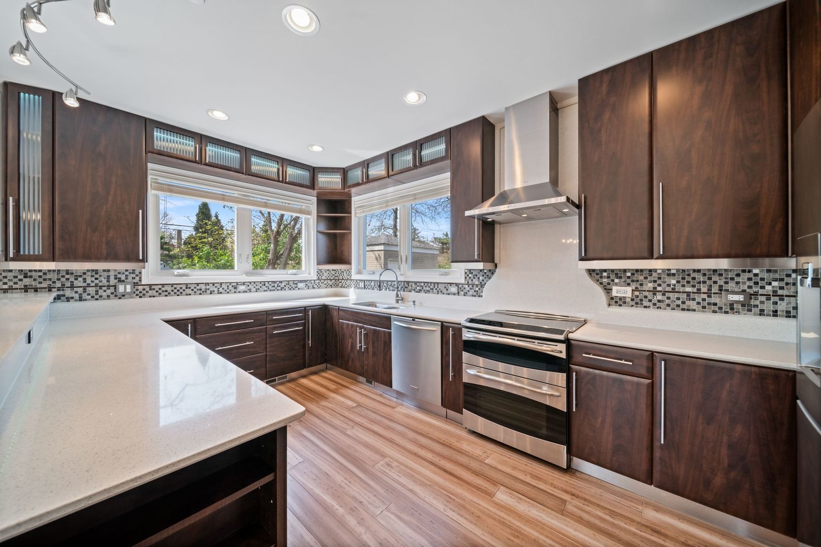 701 Oakton Street Park Ridge, IL 60068 - Photo 13 of 59 a kitchen with stainless steel appliances granite countertop wooden cabinets and a stove top oven