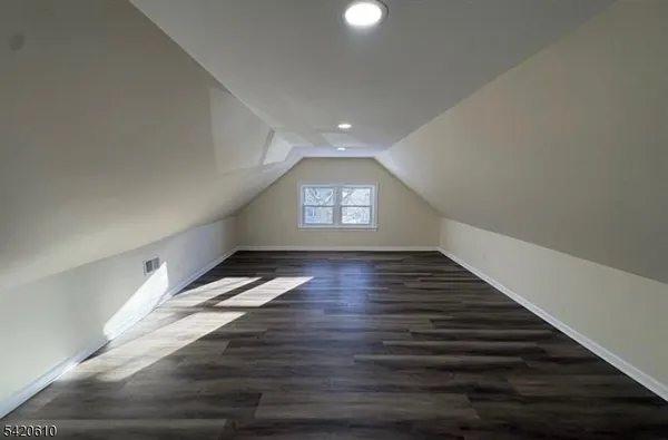 a view of an empty room and wooden floor