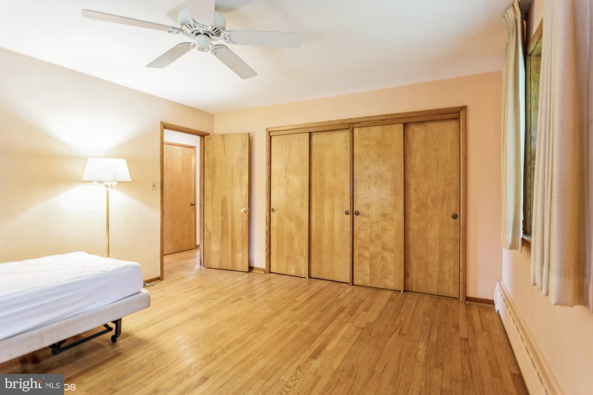 505 Whitaker Mill Road Fallston, MD 21047 - Photo 25 of 49 a spacious bedroom with a bed and a chandelier